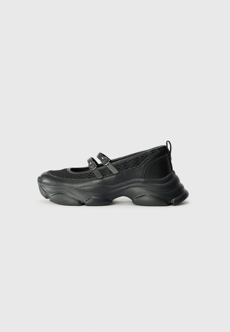 Scarpe nere con tomaia in mesh testurizzato, punta arrotondata, due cinturini regolabili e una suola ondulata spessa per un supporto maggiore.