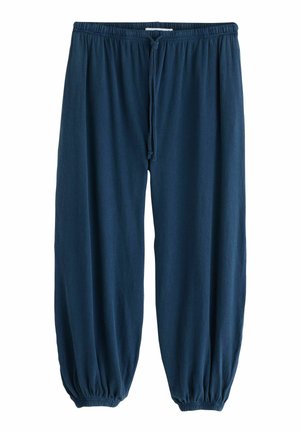 Pantalon de survêtement bleu marine ample avec taille élastique, cordon ajustable et poignets élastiques aux chevilles, présenté à plat.