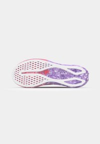 Shoe sole with a purple textured design, featuring a white midsole with perforations for breathability and a red accent at the heel.