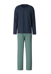 Marineblauw langemouwen V-hals top met een zak, gecombineerd met groene gebloemde broek met diamantvormen in blauw en wit. Zachte stoftextuur.