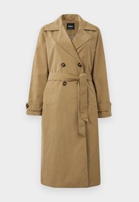 Cappotto trench color khaki realizzato in tessuto, con un frontale doppiopetto, grandi bottoni e una cintura con maniche risvoltate.
