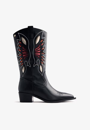 Fekete bőr cowboy csizma piros, narancs és fehér bonyolult szárnyformájú hímzéssel és rétegelt sarokkal.