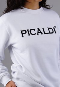 White sweatshirt made of soft fabric, featuring a crew neckline and black embroidered "PICALDI" logo across the chest.