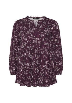Lila Blumenbluse mit langen puffärmel, einem Schlüsselloch-Ausschnitt mit Quasten und mehreren Volants am Saum. Aus weichem Stoff gefertigt.