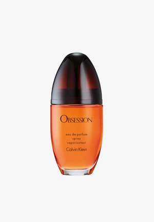 Calvin Klein Obsession eau de parfum spray i en rundad orange glasflaska med en avsmalnande mörkbrun kork och svart text på framsidan.
