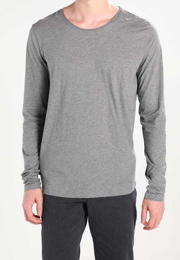 Gray long-sleeve t-shirt made of soft, lightweight material with a rounded neckline and fitted sleeves, paired with dark pants.