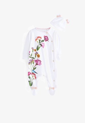 Weißer Strampler mit buntem Blumenmuster, goldenen Druckknöpfen und hellrosa Besatz. Einschließlich einer passenden Mütze mit Ohrenakzenten und Schleife.