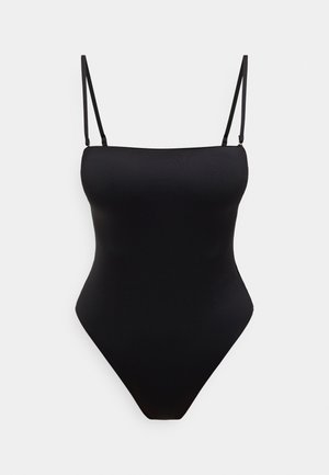 Czarny jednoczęściowy kostium kąpielowy z cienkimi, regulowanymi ramiączkami, gładką fakturą, wysokim wycięciem na nogi i bezszwowym designem. Bez dodatkowych wzorów i zdobień.