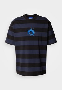 Black and navy striped T-shirt with a crew neck. Features a blue smiley face graphic with spiky accents. Made of soft fabric.