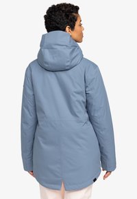 Light blue waterproof jacket with a hood, featuring a hip-length design, smooth texture, and a rear vent for added mobility.