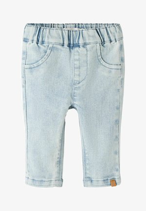 Hele sinised beebipüksid elastse vöörihma, esitaskute ja väikese pruuni sildiga vasaku säärmepi all.