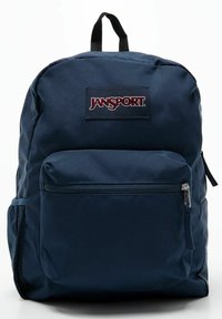 Granatowy plecak Jansport wykonany z trwałego materiału, z główną komorą, przednią kieszenią na zamek, boczną kieszenią z siatki oraz naszywką z logo.
