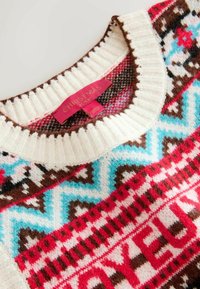 Knit sweater with a ribbed neckline, featuring a red, pink, and turquoise winter pattern, along with a red label that reads "CHRISTMAS."
