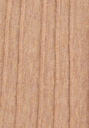 Breigaren in beige met een verticale ribbeltextuur, met subtiele kleurvariaties en een zachte, verlengde vorm. Geen opvallende accenten.