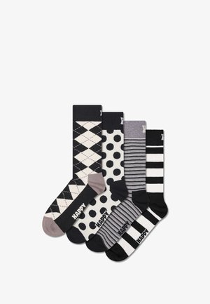 Set aus fünf Socken mit Mustern: Argyle, Punkten, Streifen und einfarbigen Designs. Die Farbpalette umfasst Schwarz, Weiß und Grautöne.