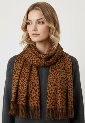 Brown leopard print scarf made of soft fabric, featuring fringed edges and a rectangular shape, worn over a dark-colored sweater.