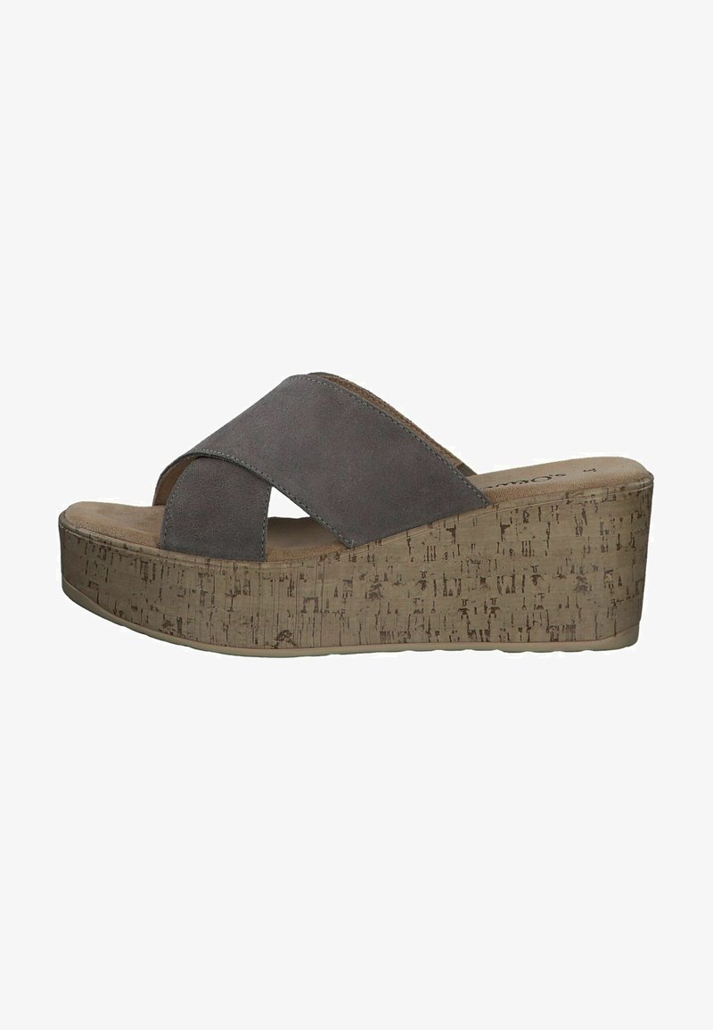 Sandales compensées en suède gris avec des brides entrecroisées et une plateforme en liège. La semelle est texturée pour une meilleure adhérence et présente un design à bout rond.