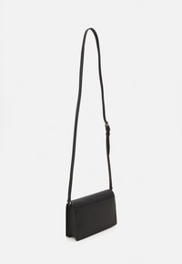 Black leather crossbody bag with a textured finish. Features a long adjustable strap and a simple rectangular shape.