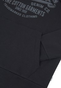 Black cotton hoodie featuring a front pocket, ribbed cuffs, and a graphic print on the chest with the brand name and year established.