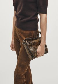 Snake-print leather handbag in brown tones, featuring a textured surface, adjustable strap, and silver hardware accents. Compact and structured design.