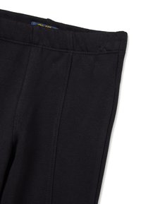 Zwarte legging gemaakt van rekbare katoenmix stof. Heeft een gladde tailleband en zijnaad voor een gestroomlijnde uitstraling.