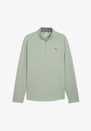 Lysegrøn sportsbluse med lange ærmer, kvart lynlås og Puma-logo på venstre bryst.