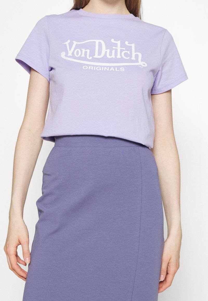 Fialové bavlněné tričko s bílým logem Von Dutch Originals, krátké rukávy a volný střih, v kombinaci s odpovídající fialovou sukní.