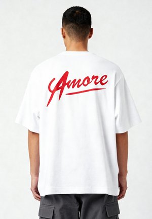 White cotton T-shirt with short sleeves, featuring a large red "Amore" text graphic on the back. Casual fit, smooth texture.