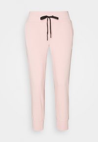 Ljust rosa joggers i mjukt tyg, med en svart dragsko, sidofickor och ribbade fållar vid anklarna.
