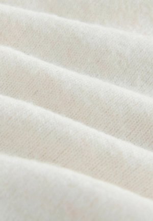 Cream-colored, textured fabric with a soft, knitted appearance, featuring subtle diagonal lines and a slight sheen.