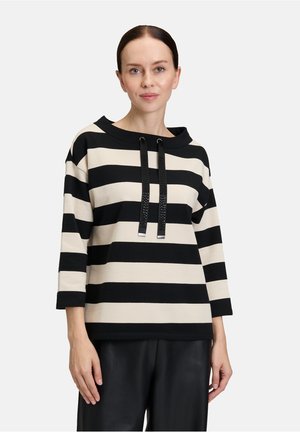 Gestreifter Pullover in Schwarz und Creme mit weitem Ausschnitt, Dreiviertelärmeln und zwei schwarzen Kordeln mit strukturierten Akzenten.