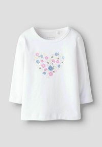 Biała koszula z długimi rękawami, ozdobiona sercowym wzorem kwiatowym w odcieniach różu, niebieskiego i zielonego. Miękka, gładka tkanina z okrągłym dekoltem.