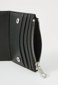 Black leather wallet with a zipper, multiple card slots, silver hardware, and a smooth texture. Features a snap closure detail.