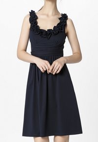 Navy blue dress with a ruffled neckline, fitted bodice, and flared skirt. Made from soft fabric, featuring smooth texture and gathers at waist.