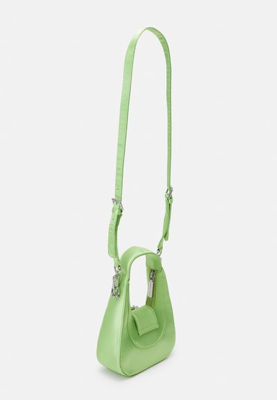Green leather handbag with a structured shape, adjustable strap, and a front pocket. Smooth texture with a glossy finish and metallic hardware.