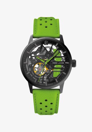 Orologio scheletrico nero con quadrante trasparente, accenti verde neon e cinturino in pelle verde perforata. Presenta un meccanismo di movimento visibile.