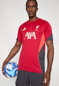 Red short-sleeve soccer jersey with black and orange accents, featuring the Liverpool FC logo and "AXA" in large white letters; nylon material.