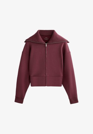 Bordó, rövidített, cipzáras felső nagy gallérral és bordázott szegélyekkel, puha anyagból, enyhe fényű és letisztult dizájnnal.