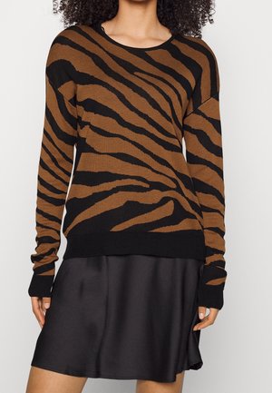 Brown and black striped knit sweater with long sleeves. Features a round neckline and ribbed cuffs. Worn over a black satin skirt.