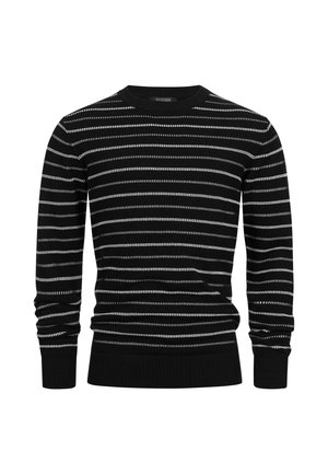 Svart og hvitstripete strikkegenser med lange ermer, rund hals og ribbestrikkede mansjetter og nederkant. Stoffet har en teksturert overflate.