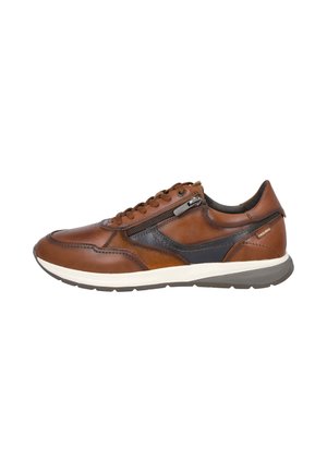 Zapatilla deportiva de cuero marrón con detalles en negro, cremallera lateral, cordones y suela blanca y gris, vista desde el lado exterior.