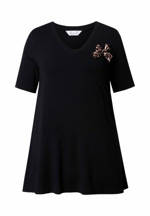 Black short-sleeve T-shirt with a V-neck and a flared bottom, featuring a leopard print bow accent on the left shoulder.