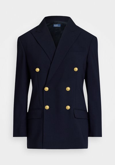 Ναυτικό σακάκι διπλής όψης με χρυσά κουμπιά, δομημένους γιακάδες, δύο μπροστινές τσέπες και λεία υφή υφάσματος. Χαλαρός αλλά εκλεπτυσμένος σχεδιασμός.