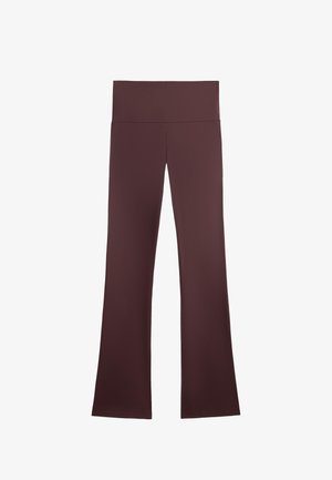 Braune Yogahosen mit einem breiten, hohen Bund und ausgestellten Beinen. Hergestellt aus glattem, dehnbarem Stoff mit sauberen Kanten und ohne sichtbare Muster.