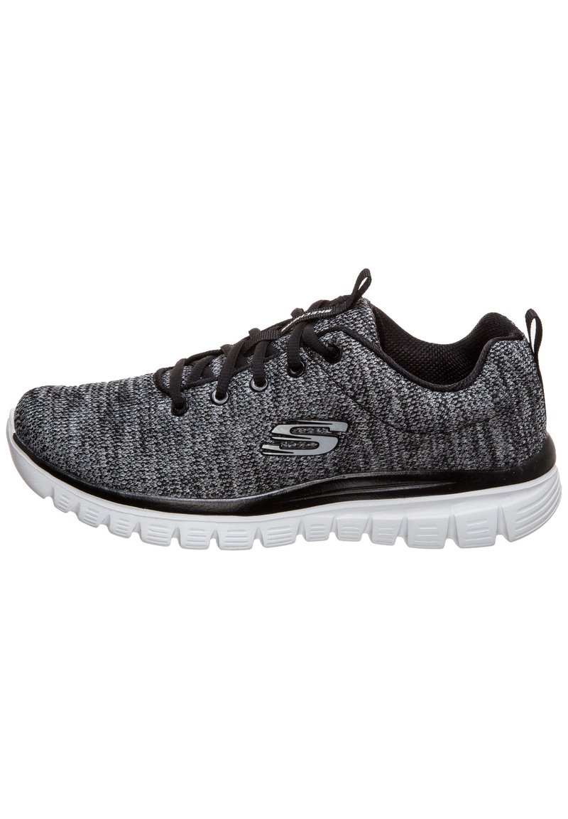 Sneaker lavorato a maglia in nero e grigio con una finitura texturizzata, suola bianca e dettagli neri. Presenta lacci rotondi e un logo sul lato.