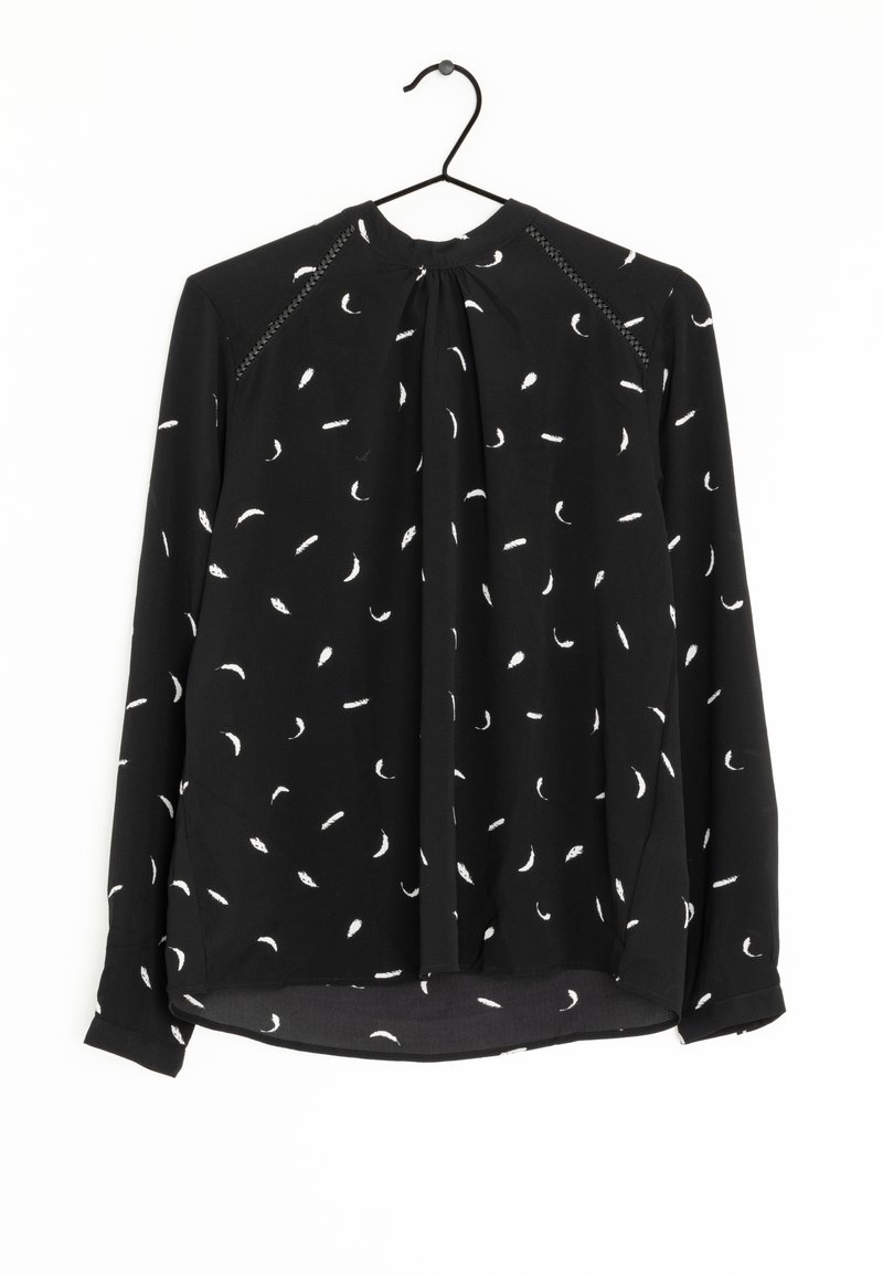 Blouse noire à manches longues avec un nœud au cou, ornée d'un délicat motif de plumes blanches et d'accents texturés le long des épaules.