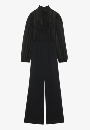 Schwarzer Jumpsuit mit hohem Kragen und langen Puffärmeln. Durchsichtiger Oberteil-Bereich mit gerafften Details; weit geschnittene Beine aus mattem Stoff.