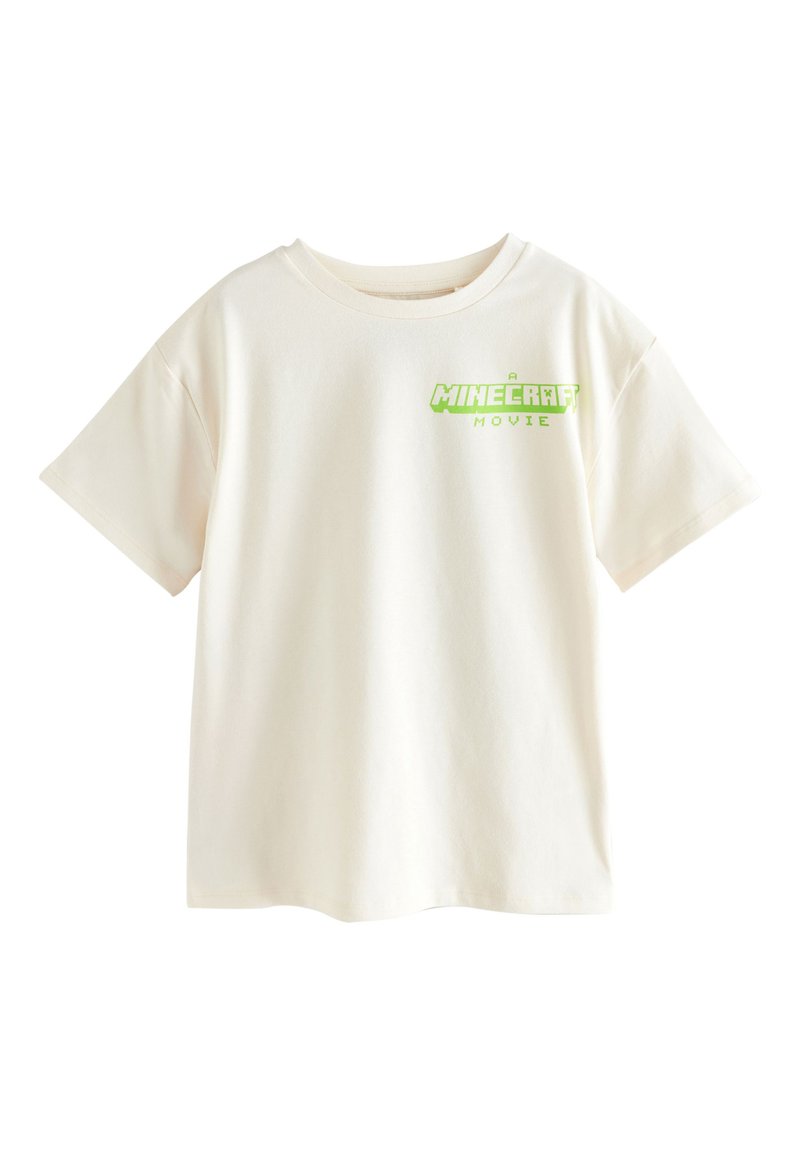 Baumwoll-T-Shirt in cremefarben mit kurzen Ärmeln und rundem Ausschnitt. Mit grünem Grafikdruck mit der Aufschrift "A MINECRAFT MOVIE."