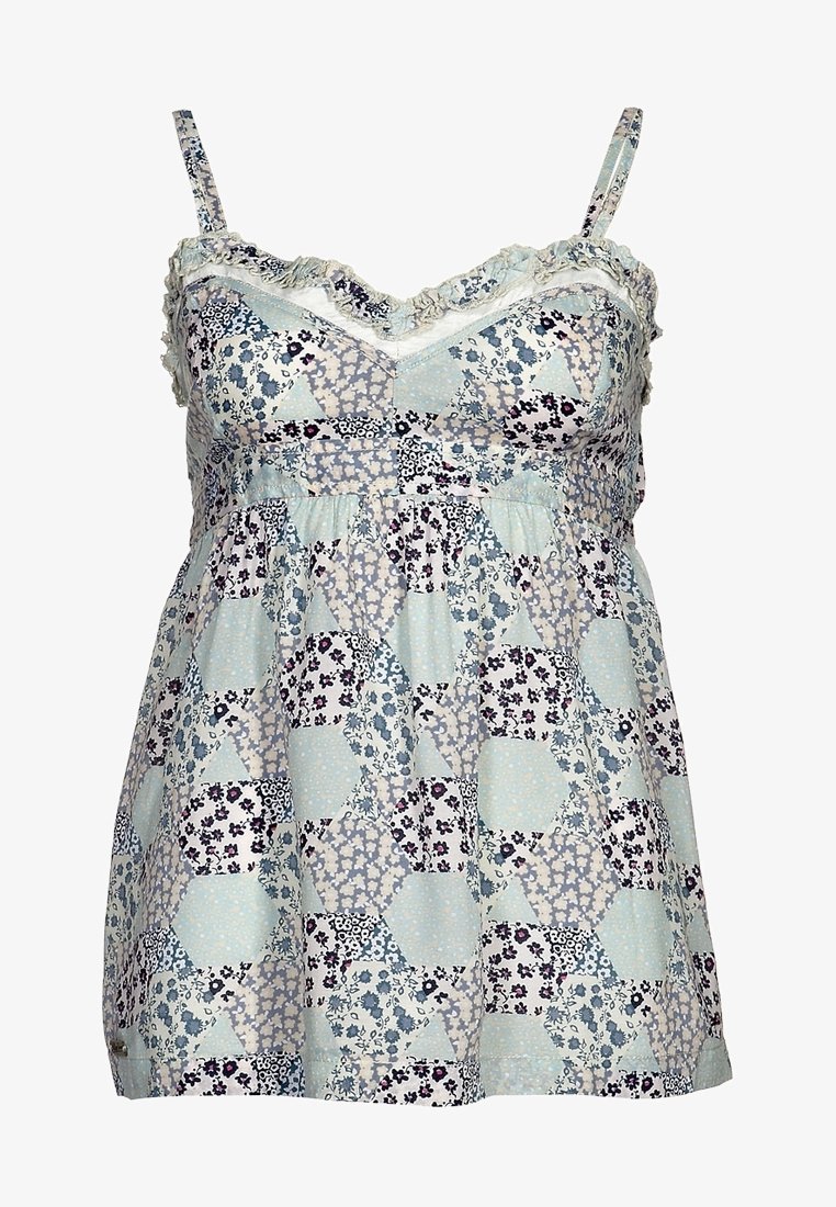 Ljusblå blommig mönstrad kamisol med spagettistroppar, med volangkant och draperad midja. Bomullstyg med varierande blommönster.