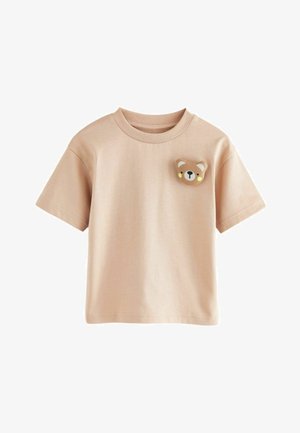 Kurzärmliges, hellbeiges T-Shirt aus weichem Stoff, mit einem Bärenkopf-Graphic auf der Brust in braunen und gelben Akzenten.